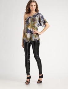 A splotchy abstract print on pure silk in an elegant and edgy top with a crossover-look front and softly draped details.Diagonal neckline One draped, elbow-length sleeve Angled hem Hidden side zipper About 27 from shoulder to hem Silk Dry clean Imported