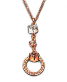 A design that speaks volumes about elegance -- this gold tone mixed metal pendant flaunts a cubic-cut clear Swarovski crystal on top. Followed by two Golden Shadow Swarovski crystals, the pendant ends with a ring of moonlight and golden shadow Swarovski crystals set in pavé. Approximate length: 15 inches. Approximate drop: 2 inches. A design that speaks volumes about elegance -- this gold tone mixed metal pendant flaunts a cubic-cut clear Swarovski crystal on top. Followed by two Golden Shadow Swarovski crystals, the pendant ends with a ring of moonlight and golden shadow Swarovski crystals set in pavé. Approximate length: 15 inches. Approximate drop: 2 inches.
