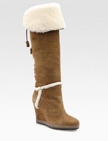 Buttery suede wedge with a lace-up back and tassel laces, topped with a fold-over shearling cuff and lining. Self-covered wedge, 3¾ (95mm) Covered platform, ¾ (20mm) Compares to a 3 heel (75mm) Shaft, 18 Leg circumference, 14 Suede upper Shearling lining Rubber sole Padded insole Imported