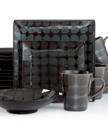 Anything but square, Gibson's Mythos dinnerware set is finished in a brilliant reactive glaze that ensures no two pieces are exactly alike. Its spotty design and dark palette make a bold statement in modern settings. Anything but square, Gibson's Mythos dinnerware set is finished in a brilliant reactive glaze that ensures no two pieces are exactly alike. Its spotty design and dark palette make a bold statement in modern settings.