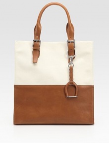 A structured shape updated with colorblocked leather and canvas, finished with a signature dangling stirrup.Adjustable leather top handles with buckle closures, 4½-7¼ dropRemovable dangling stirrupMagnetic top closureOne inside zip pocketOne inside open pocketOne cellphone pocketCanvas lining12¾W X 13¼H X 5DMade in Italy A structured shape updated with colorblocked leather and canvas, finished with a signature dangling stirrup.Adjustable leather top handles with buckle closures, 4½-7¼ dropRemovable dangling stirrupMagnetic top closureOne inside zip pocketOne inside open pocketOne cellphone pocketCanvas lining12¾W X 13¼H X 5DMade in Italy