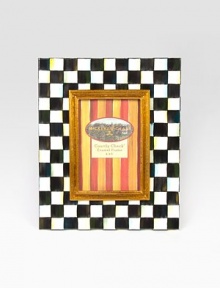 Display your treasured moments in this opulent, hand-painted frame with gilt inner molding.Hand-painted checks on enameled steelGlassAccommodates a 4 X 6 photographOverall, 9 X 11Linen-covered easel and backImported