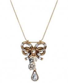 A vintage-inspired style your grandmother would love. This pendant necklace from Betsey Johnson features a bow encrusted with crystal accents, a crystal teardrop, crystal fireball and silver tone bubble heart. Crafted in antiqued gold tone mixed metal. Approximate length: 16 inches + 3-inch extender. Approximate drop: 2 inches.