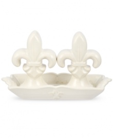 Shaped like the iconic lilies, decorated Fleur de Lys salt and pepper shakers from Portmeirion set tables in the French tradition. Featuring ivory stoneware in a scalloped dish for an extra dash of elegance every day. Shaped like the iconic lilies, decorated Fleur de Lys salt and pepper shakers from Portmeirion set tables in the French tradition. Featuring ivory stoneware in a scalloped dish for an extra dash of elegance every day.