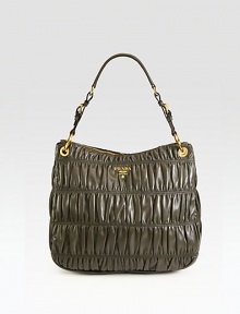 Supple leather in a signature ruched design with buckle detail and an adjustable strap.Adjustable shoulder strap, 9-9¾ dropTop zip closureOne inside zip pocketThree inside open pocketsSignature jacquard lining14W X 13H X 5¼DMade in Italy Supple leather in a signature ruched design with buckle detail and an adjustable strap.Adjustable shoulder strap, 9-9¾ dropTop zip closureOne inside zip pocketThree inside open pocketsSignature jacquard lining14W X 13H X 5¼DMade in Italy