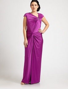 A bejeweled, floor-skimming satin gown that will turn heads this season. The gathered, twist-front bodice is especially flattering for curvy figures.Asymmetrical necklineCap sleevesJewel embellishmentGathered, twist-front bodiceConcealed back zipperAbout 46 from natural waist93% polyester/7% spandexDry cleanImported