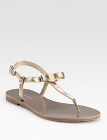 Adjustable metallic leather straps, sweetened by a dainty bow. Metallic leather upperLeather liningRubber solePadded insoleMade in ItalyOUR FIT MODEL RECOMMENDS ordering one half size down as this style runs large. 