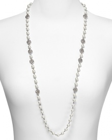 Take an upper crust approach to accessorizing with this long strand pearl from Lauren Ralph Lauren. Embellished with crystal stations, it speaks to a refined aesthetic.