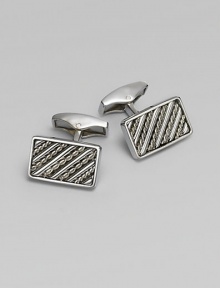 Rectangular sterling silver links are set with hand-twisted wire inlaid within silver bars. Sterling silver About ¼ X ½ Made in the United Kingdom Rectangular sterling silver links are set with hand-twisted wire inlaid within silver bars. Sterling silver About ¼ X ½ Made in the United Kingdom