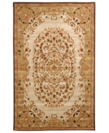 Traditionally inspired elegance. With an ornate motif in soft beige and green hues, Safavieh's Heritage rug takes any room from attractive to stunning in moments. Hand-tufted of pure wool with strong cotton backing, the rug can withstand even the most highly traveled areas of your home. (Clearance)