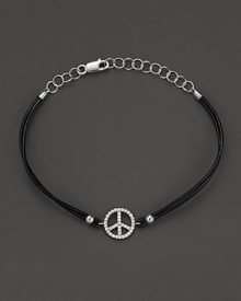 Diamonds, set in white gold, form a dazzling peace sign on this leather bracelet from Meira T.