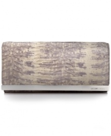 Organization with elegance. Chic croc-embossed leather and gleaming signature hardware offer instant appeal to this MICHAEL Michael Kors clutch that discretely conceals a slim shoulder strap along with plenty of compartments for cash, cards, ID and lipstick. Organization with elegance. Chic croc-embossed leather and gleaming signature hardware offer instant appeal to this MICHAEL Michael Kors clutch that discretely conceals a slim shoulder strap along with plenty of compartments for cash, cards, ID and lipstick.