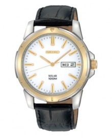 Traditionally handsome style combines with modern solar power in this watch by Seiko. Black croc-embossed leather strap and round stainless steel case with gold tone bezel, 39mm. White dial features applied gold tone stick indices, black minute track, day and date window at three o'clock, LumiBrite hands and logo. Solar-powered quartz movement. Water resistant to 100 meters. Three-year limited warranty. Traditionally handsome style combines with modern solar power in this watch by Seiko. Black croc-embossed leather strap and round stainless steel case with gold tone bezel, 39mm. White dial features applied gold tone stick indices, black minute track, day and date window at three o'clock, LumiBrite hands and logo. Solar-powered quartz movement. Water resistant to 100 meters. Three-year limited warranty.
