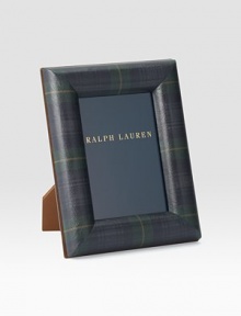 An elegant display for a cherished photo, rendered in supple saddle leather with a nickel-plated brass finish.Holds one 5 X 7 photoLeather and nickel-plated brassImported An elegant display for a cherished photo, rendered in supple saddle leather with a nickel-plated brass finish.Holds one 5 X 7 photoLeather and nickel-plated brassImported