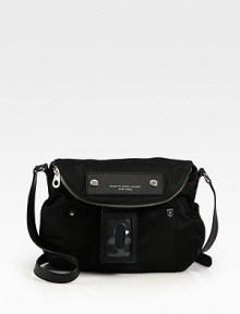 A slouchy flap design crafted of sturdy nylon with leather trim, finished with an over-sized luggage tag.Adjustable shoulder strap, 18-21 dropMagnetic flap closure with top zip compartmentOne outside open pocketOne inside zip pocketTwo inside open pocketsNylon lining11½W X 11H X 3¼DImported A slouchy flap design crafted of sturdy nylon with leather trim, finished with an over-sized luggage tag.Adjustable shoulder strap, 18-21 dropMagnetic flap closure with top zip compartmentOne outside open pocketOne inside zip pocketTwo inside open pocketsNylon lining11½W X 11H X 3¼DImported
