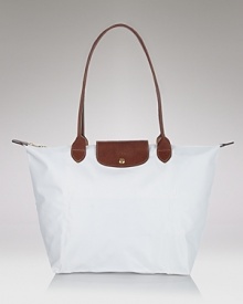 A timeless nod to French style, Longchamp's nylon tote perfects carryall style. This roomy and packable bag is prime for the chic girl, whether she's in-town or overseas. A timeless nod to French style, Longchamp's nylon tote perfects carryall style. This roomy and packable bag is prime for the chic girl, whether she's in-town or overseas.