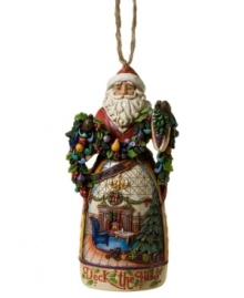 Christmas comes early in the elaborate carved skirt of Jim Shore's Deck the Halls Santa ornament. A picture-perfect holiday morning is topped with St. Nick, his arms full of colorful garland.