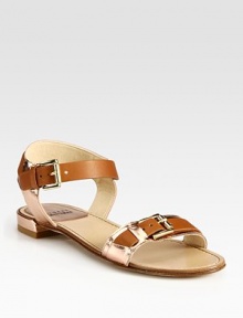 Vivacious patent leather flat surrounded by shimmery metallic leather buckles. Patent leather and metallic leather upperLeather lining and soleImportedOUR FIT MODEL RECOMMENDS ordering one half size down as this style runs large. 