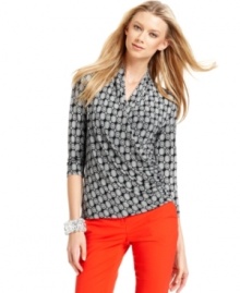 Vince Camuto's top features a flattering faux-wrap silhouette and a striking medallion print.