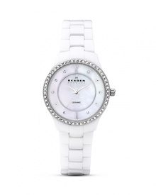 An elegant timepiece with a hint of glam, this watch features a soft round silhouette and a delicate bezel adorned with Swarovski crystals set against a pure white backdrop.