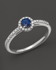 A sapphire center stone with diamonds in a 14K white gold ring.