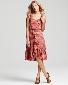 Romantic whimsy arrives with a striking Tory Burch polka dot dress, featuring flounced ruffle trim and a feminine, vintage-inspired silhouette.