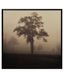 Almost eerie in black and white, this photo print sets a quiet, contemplative mood. A lone tree comes into focus despite dense fog while, in the distance, others are barely visible. Finished with a narrow black frame.