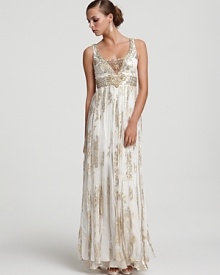 Opulent details such as an embellished mesh V-neck and flowing skirt panels place this metallic silk jacquard gown from Sue Wong in a style league of its own. Opulent details such as an embellished mesh V-neck and flowing skirt panels place this metallic silk jacquard gown from Sue Wong in a style league of its own.