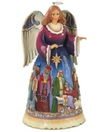 A colorific nativity scene paints itself across this folk-inspired angel's dress and adds to the hopeful & peaceful aura of this accent piece.