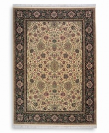 Inspired by the easily recognizable and intricately beautiful textiles of the Kirman region of ancient Persia, this Indo-Kirman rug features graceful floral designs in a rich palette of individually-dyed colors including indigo, soft blues, peach-corals, golds, lavender, and a multitude of soft greens. Patterned on an antique carpet woven circa 1910, it has a soft luster-wash that imparts a soft vintage finish.