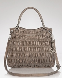 Go both classic and cool with this quilted style from MICHAEL Michael Kors. Featuring a prettified version of a favorite shape - the satchel - this bag lends luxury to every look. Go both classic and cool with this quilted style from MICHAEL Michael Kors. Featuring a prettified version of a favorite shape - the satchel - this bag lends luxury to every look.