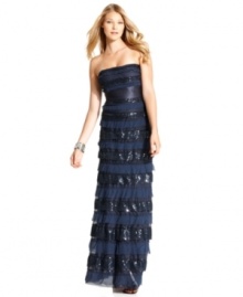 BCBGMAXAZRIA creates a captivating, statuesque evening gown using tiers of swiss dot lace, sequins and softly textured fabric.