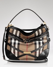 Belted details add equestrian charm to this Burberry hobo, iconic in the brand's signature check print. Belted details add equestrian charm to this Burberry hobo, iconic in the brand's signature check print.