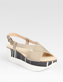 Two-tone, mixed-media platform wedge design accented by supple leather criss-cross straps. Rubber and wooden wedge, 2 (50mm)Rubber and wooden platform, 1½ (40mm)Compares to a ½ heel (15mm)Leather upperLeather liningRubber soleMade in Italy