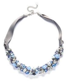 Shake up your style with c.A.K.e. by Ali Khan's shimmery cluster necklace. Blue and clear crystal beads (10-14 mm) add a sparkling effect to a trendy grosgrain ribbon and mixed metal setting. Approximate length: 18 inches + 3-inch extender.