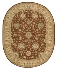 Bring new life to any room of your home. This gorgeous rug, sprouting intricate designs of vinery and blossoming flowers, opens up any space with warm tones of burnt red and beige. With an all-wool construction, accented with rich silk highlights, this stylish Nourison 2000 import is ultra-durable and luxuriously soft to the touch.