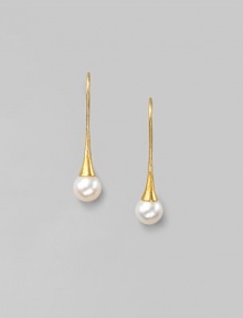 Delicate freshwater pearls dangle from hand-hammered 24k gold settings. 8mm white, round freshwater pearls 24k yellow gold Length, about 1¼ 22k gold ear wire Imported