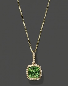 Diamonds frame a faceted peridot, set in 14K yellow gold.