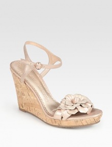 Metallic leather design in full bloom with a ladylike flower embellishment and earthy cork wedge. Cork wedge, 3½ (90mm)Cork platform, ½ (15mm)Compares to a 3 heel (75mm)Metallic leather upperLeather liningRubber solePadded insoleImported