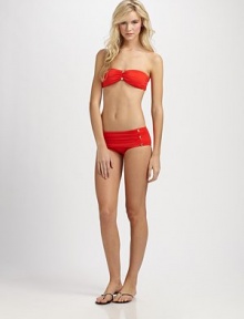 Glamorous gilded buttons adorn the front of this sexy top with feminine ruching.Bandeau topRemovable halter strap and cupsBack tie closure85% nylon/15% spandexFully linedHand washImported Please note: Bikini bottom sold separately. 