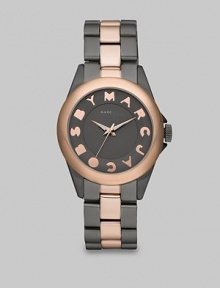 A high-contrast design with a playful logo accented dial. Quartz movementWater resistant to 5 ATMRound grey ion-plated stainless steel case, 36mm (1.4)Smooth rose goldtone ion-plated bezelGrey dialLogo hour markersSecond hand Grey and goldtone ion-plated stainless steel link bracelet, 18mm wide (0.7)Imported