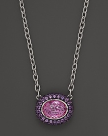 Sterling silver chain necklace adorned with an oval pink corundum pendant with amethyst pave frame. By Judith Ripka.