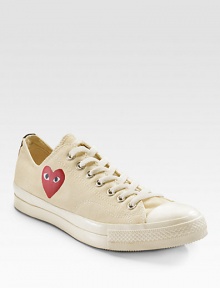 An eye-catching heart peers out from the side of these canvas classics, finished with a contrast stripe at the heel. Rubber toe Lace-up front Painted heart on side Back stripe Padded insole Rubber sole ImportedOUR FIT MODEL RECOMMENDS ordering true whole size; ½ sizes should order the next whole size down. 