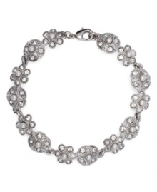 Freshen your look with this sparkling, floral motif. Monet's elegant flex bracelet shines with the addition of white glass pearls and crystal embellishments. Crafted in silver tone mixed metal. Approximate length: 7-1/2 inches. Freshen your look with this sparkling, floral motif. Monet's elegant flex bracelet shines with the addition of white glass pearls and crystal embellishments. Crafted in silver tone mixed metal. Approximate length: 7-1/2 inches.