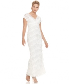 This romantic Onyx lace white dress captures a unique vintage look with its cascading, crisscrossing tiers of lace and scalloped hem.