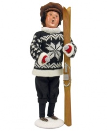 Finished with his run and ready for cocoa, this sweater-clad skier takes a moment to admire the snow-capped mountain he's just conquered. The perfect Byers' Choice figurine for ski- and snowboarding families!