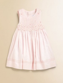 She'll be a real heartbreaker in this beautiful party dress with smocked bodice and flouncy, full skirt.ScoopneckSleevelessBack buttonsBack ribbon-tie waistFull skirtPolyester/cottonDry cleanImported Please note: Number of buttons may vary depending on size ordered. 