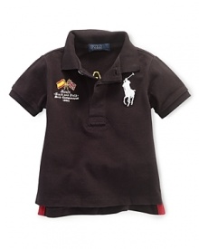 A preppy short-sleeved polo shirt in breathable cotton mesh is accented with country embroidery, celebrating Team USA's participation in the 2012 Olympics. A preppy short-sleeved polo shirt in breathable cotton mesh is accented with country embroidery, celebrating Team USA's participation in the 2012 Olympics.