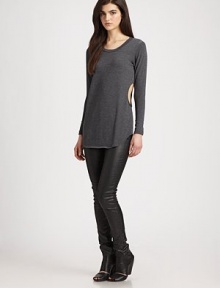 Side cutouts and a lengthy fit give a casual-cool vibe to this soft jersey knit. RoundneckLong sleevesCutout sidesLonger length hits below the hips48% polyester/48% rayon/4% spandexDry cleanMade in USAModel shown is 5'10 (177cm) wearing US size Small.