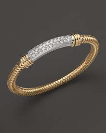 Sparkling diamonds decorate a gleaming 18K gold Roberto Coin bracelet.